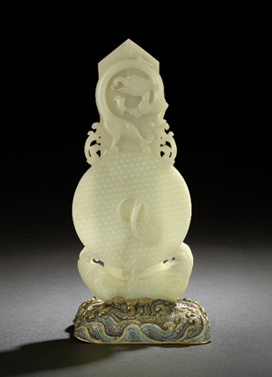 A complex carving of precious white jade soared to $334,000 in May at a New Orleans Auction Galleries sale. The 18th century pi disk is topped by a carved dragon; twelve symbols are carved in the tablet on the reverse.  Courtesy New Orleans Auction Galleries